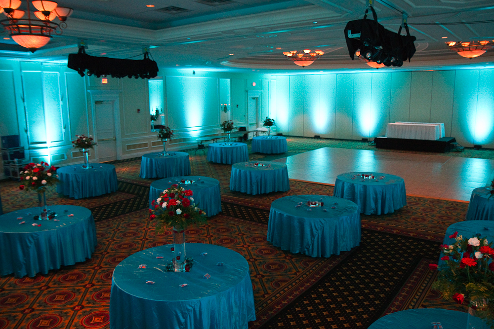 For this event the groom wanted the lighting color to match the tablecloths